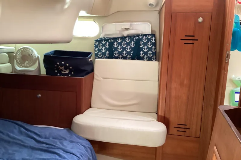 Slide: The Image of Interior of 2001 Hunter 380 sailboat with wooden cabinetry and cushioned seating. - 41