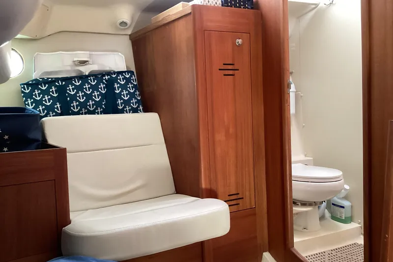 Slide: The Image of Interior of 2001 Hunter 380 sailboat with seating and compact bathroom. - 43