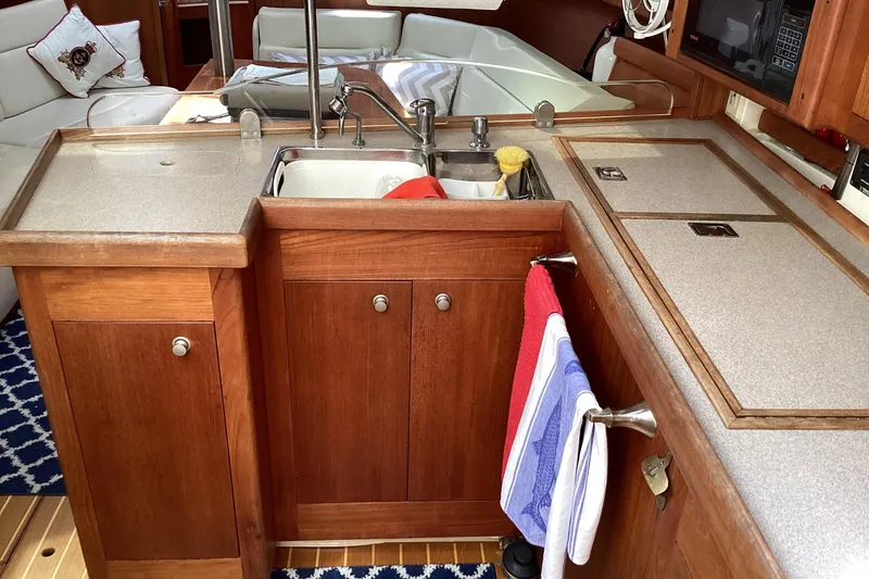 Slide: The Image of Wooden kitchen area in a 2001 Hunter 380 yacht with sink and countertop. - 46