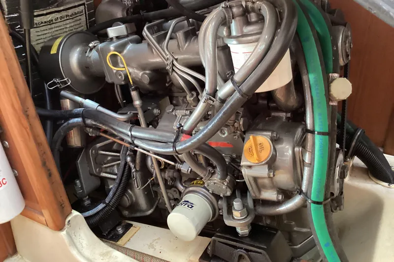 Slide: The Image of Engine compartment of a 2001 Hunter 380 sailboat, showcasing detailed mechanical components. - 49