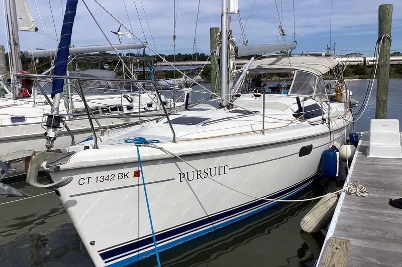 Slide: The Image of Sailboat docked at marina, 2001 Hunter 380 model, named "Pursuit." - 5