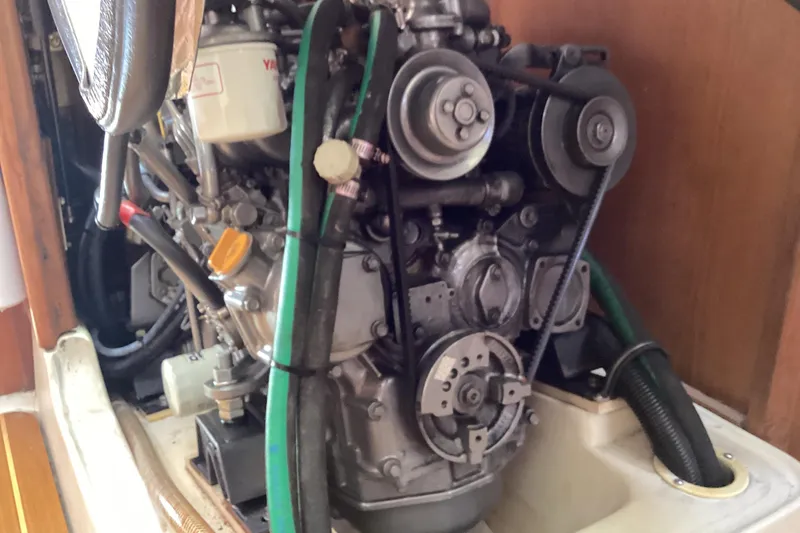 Slide: The Image of Engine compartment of a 2001 Hunter 380 sailboat, showcasing mechanical components and hoses. - 50