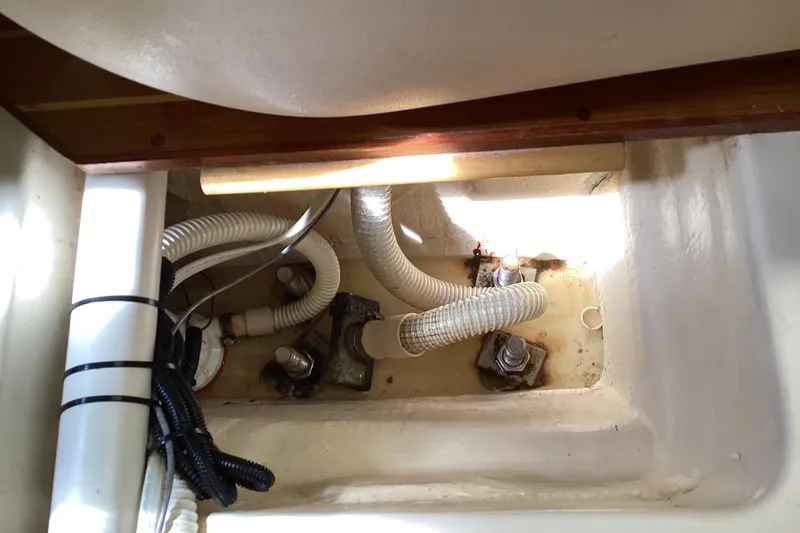 Slide: The Image of Interior view of a 2001 Hunter 380 sailboat showing plumbing and fittings. - 52