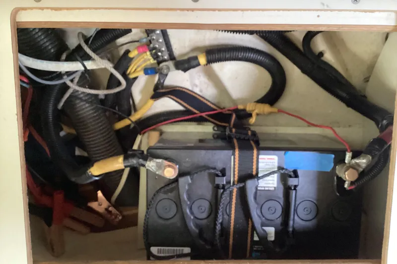 Slide: The Image of Battery compartment of a 2001 Hunter 380 sailboat with wiring and connections. - 53