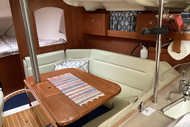 Slide: The Image of Cozy interior of a 2001 Hunter 380 sailboat with dining area and kitchenette. - 56