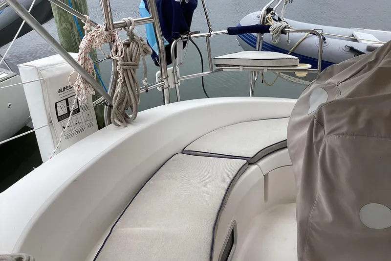 Slide: The Image of Cockpit of 2001 Hunter 380 sailboat with cushioned seating and nautical equipment. - 57