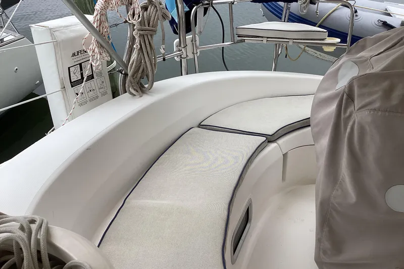 Slide: The Image of Cockpit of 2001 Hunter 380 sailboat with cushioned seating and nautical equipment. - 58