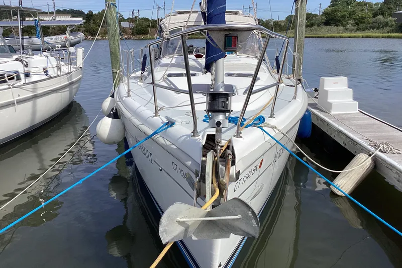 Slide: The Image of 2001 Hunter 380 sailboat docked in a marina, front view with anchor and ropes. - 6