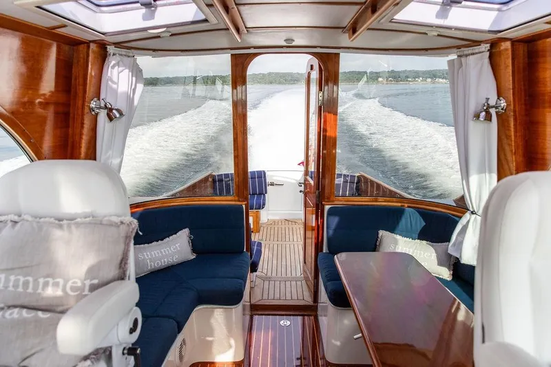 Slide: The Image of Luxurious interior of 2002 Hinckley Talaria 44 yacht with elegant wood finish and plush seating. - 18