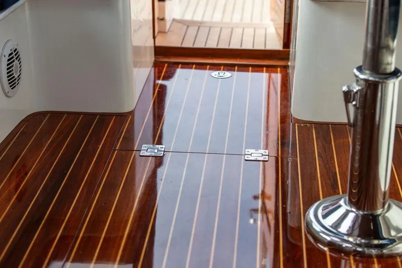 Slide: The Image of Hinckley Talaria 44 (2002) yacht interior with polished wooden flooring and chrome details. - 21