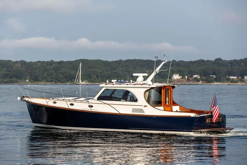 The Image of 2002 Hinckley Talaria 44 yacht cruising on calm waters with scenic background. - 0
