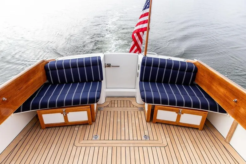 Slide: The Image of Hinckley Talaria 44 yacht deck with striped seating and American flag, 2002 model. - 14