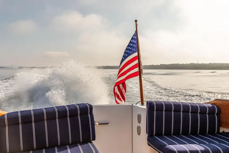 Slide: The Image of Hinckley Talaria 44 yacht cruising, American flag waving, 2002 model, ocean view. - 15