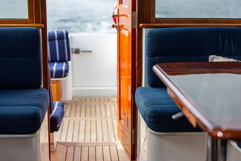 Slide: The Image of Hinckley Talaria 44 yacht interior with blue seating and wooden accents, 2002 model. - 16