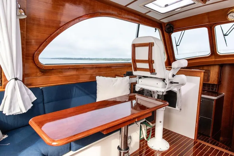 Slide: The Image of Interior of 2002 Hinckley Talaria 44 yacht with wooden accents and seating area. - 19