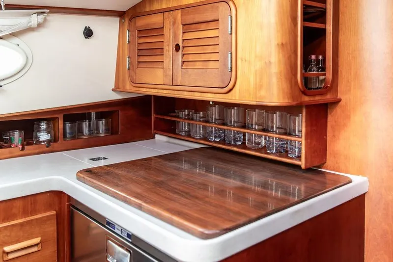Slide: The Image of 2002 Hinckley Talaria 44 yacht interior with wooden cabinetry and countertop. - 30