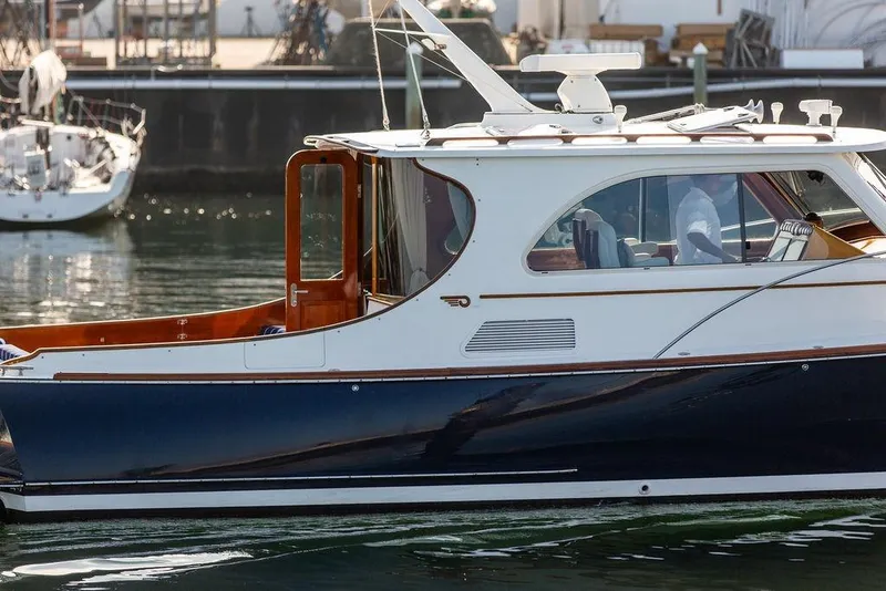 Slide: The Image of 2002 Hinckley Talaria 44 yacht with sleek design, docked in a marina. - 9