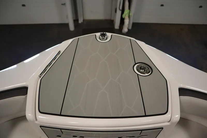 Slide: The Image of 2025 Yamaha Boats 252XE bow with sleek, modern design and textured deck. - 11
