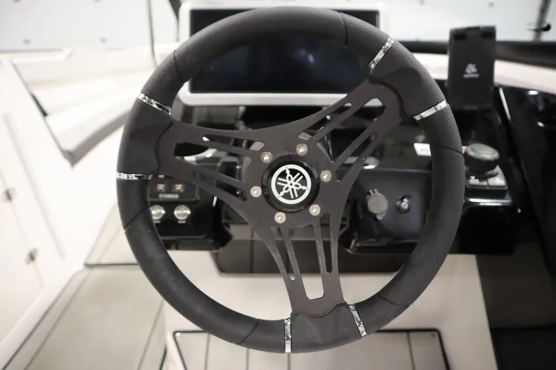 Slide: The Image of Steering wheel of 2025 Yamaha Boats 252XE, featuring sleek design and modern controls. - 19