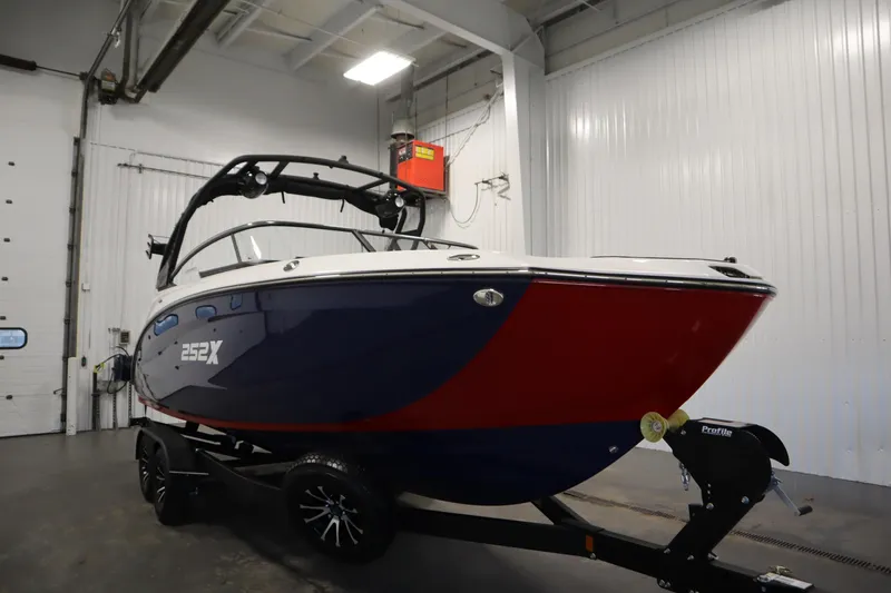 Slide: The Image of 2025 Yamaha Boats 252XE in a showroom, featuring sleek design and vibrant colors. - 2