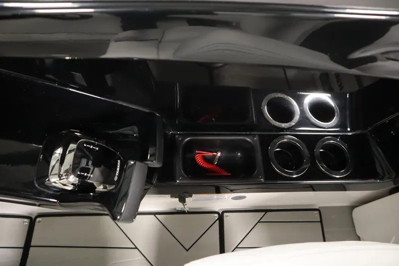 Slide: The Image of 2025 Yamaha Boats 252XE interior with control panel and cup holders. - 23