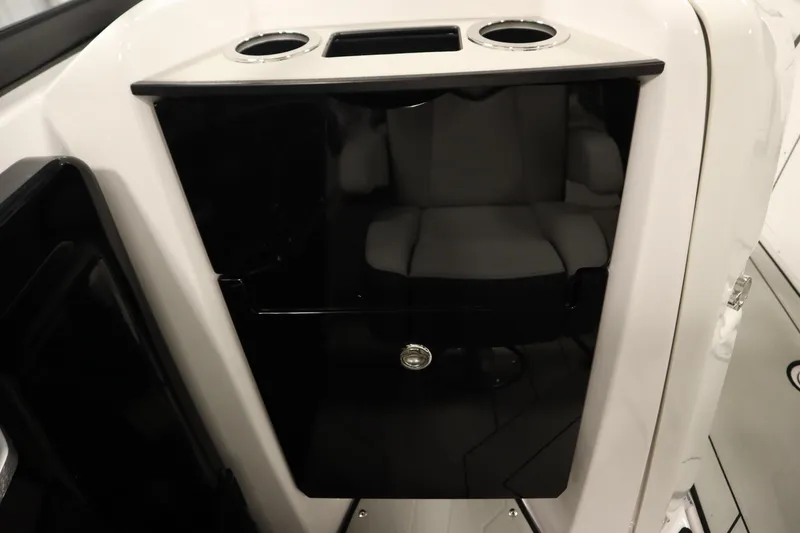 Slide: The Image of 2025 Yamaha Boats 252XE interior with cup holders and storage compartment. - 28