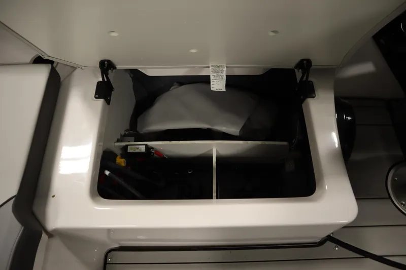 Slide: The Image of Open storage compartment in 2025 Yamaha Boats 252XE, showcasing interior details and components. - 31