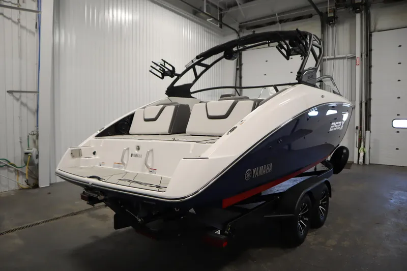 Slide: The Image of 2025 Yamaha Boats 252XE in a garage, showcasing sleek design and modern features. - 4