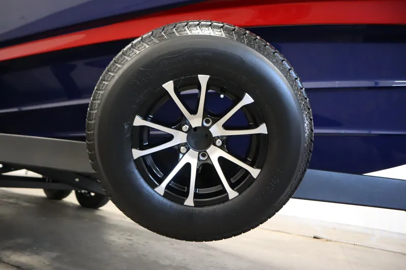 Slide: The Image of Trailer wheel of 2025 Yamaha Boats 252XE, featuring sleek black and silver design. - 45