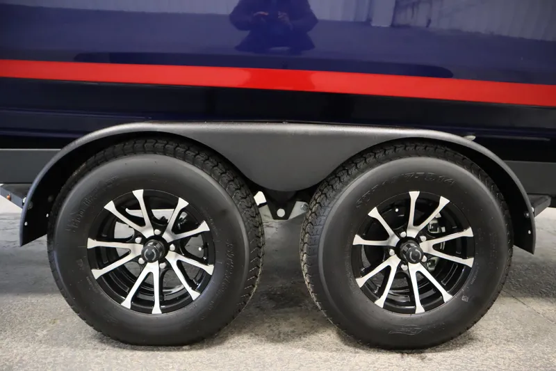 Slide: The Image of Trailer wheels of 2025 Yamaha Boats 252XE with sleek black and silver rims. - 47
