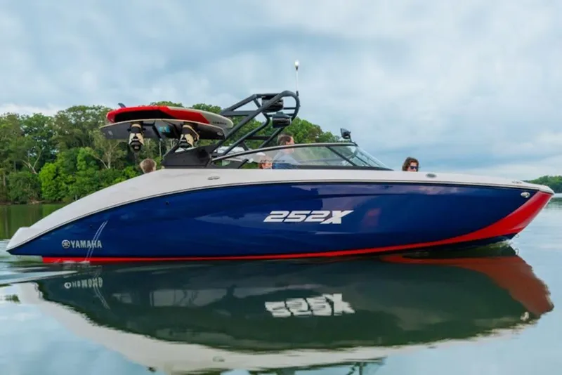Slide: The Image of 2025 Yamaha Boats 252XE on calm water, showcasing sleek design and vibrant colors. - 49