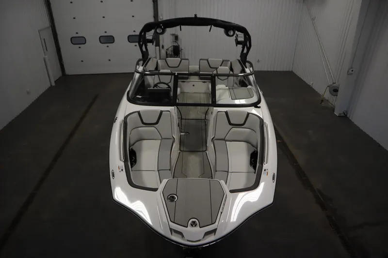 Slide: The Image of 2025 Yamaha Boats 252XE, sleek design, spacious seating, indoor showroom display. - 8