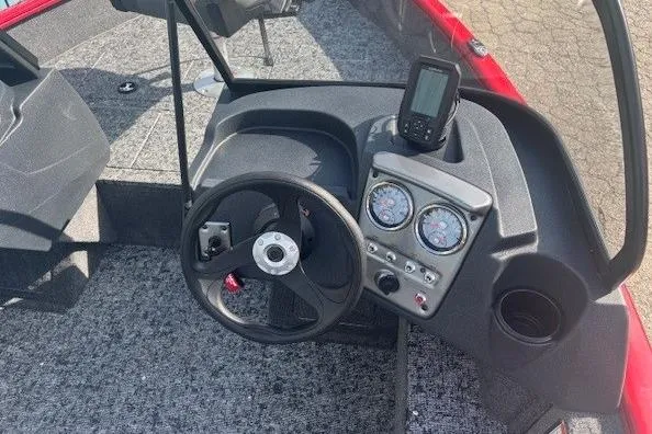 Slide: The Image of 2026 Tracker Pro Guide V-16 WT boat dashboard with steering wheel and gauges. - 11