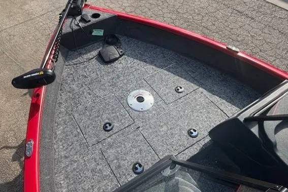 Slide: The Image of 2026 Tracker Pro Guide V-16 WT boat deck with red trim and gray carpeting. - 7