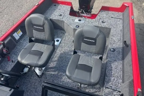 Slide: The Image of 2026 Tracker Pro Guide V-16 WT boat interior with two gray seats. - 9