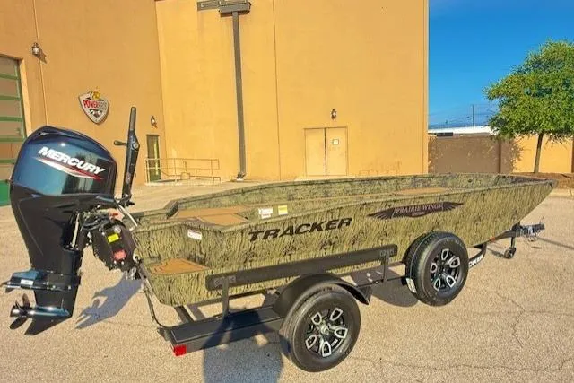 Slide: The Image of 2026 Tracker Grizzly 1650 T Prairie Wings Edition boat with Mercury engine on trailer. - 2