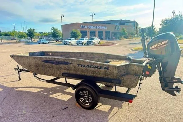 Slide: The Image of 2026 Tracker Grizzly 1650 T Prairie Wings Edition boat with Mercury engine at service center. - 3