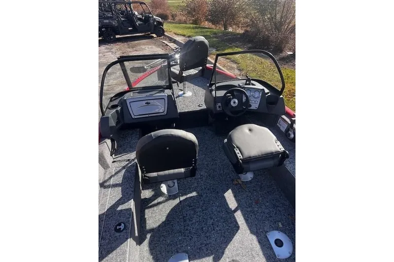 Slide: The Image of 2026 Tracker Pro Guide V-16 WT boat interior with dual seats and steering console. - 51