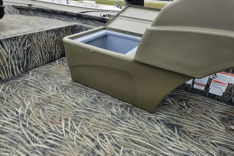 Slide: The Image of 2026 Tracker Grizzly 1754 SC boat interior with camouflage design and storage compartment. - 11