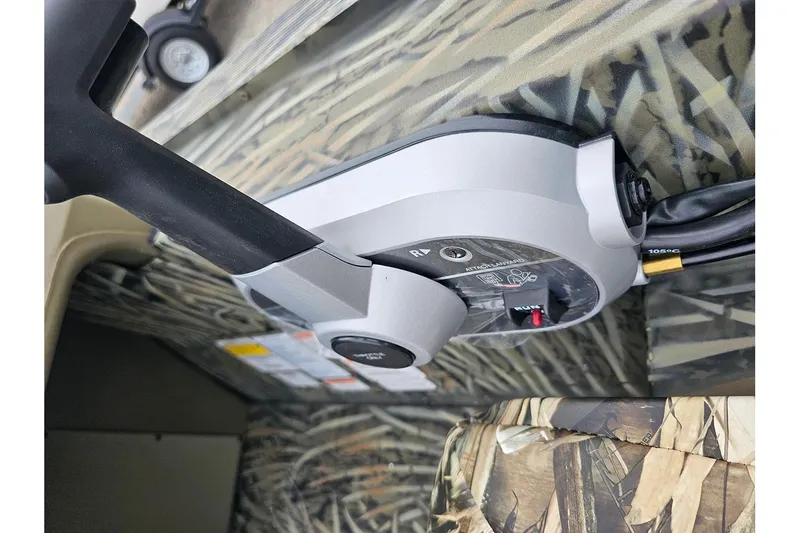 Slide: The Image of Close-up of 2026 Tracker Grizzly 1754 SC boat control panel with camouflage design. - 15