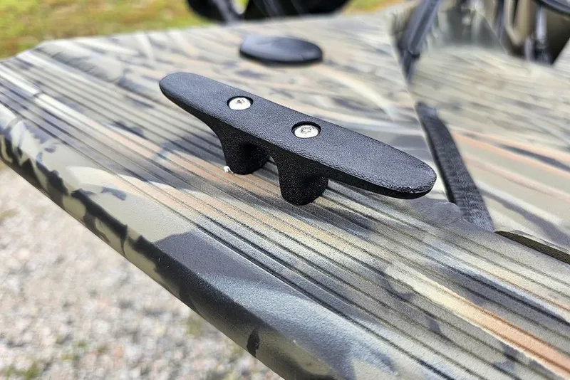 Slide: The Image of 2026 Tracker Grizzly 1754 SC boat cleat on camo-patterned surface. - 17