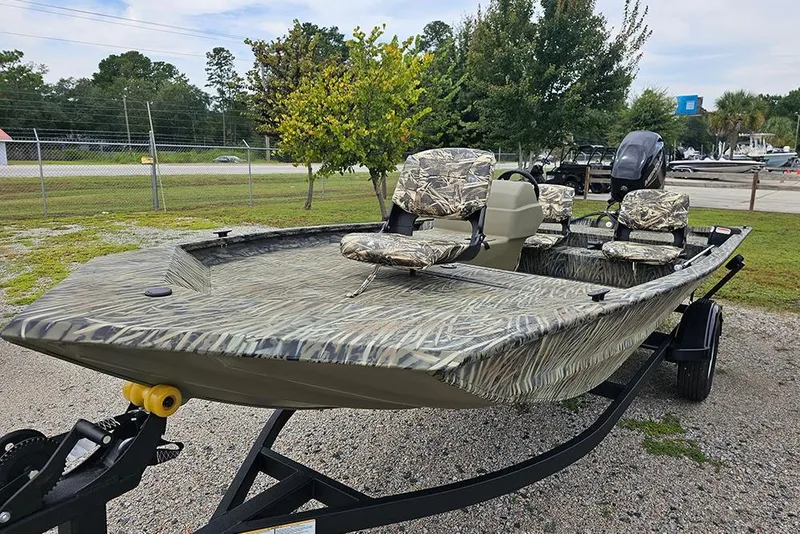 Slide: The Image of 2026 Tracker Grizzly 1754 SC boat with camouflage design on a trailer. - 5