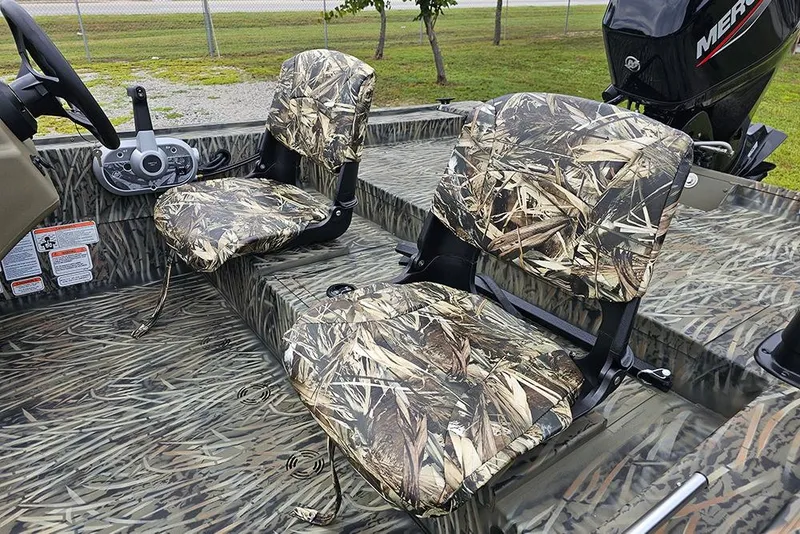Slide: The Image of 2026 Tracker Grizzly 1754 SC boat with camo seats and steering console. - 8