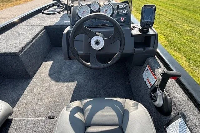 Slide: The Image of 2026 Tracker Pro 170 boat interior with steering wheel, gauges, and navigation system. - 2