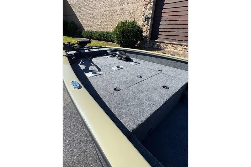 Slide: The Image of 2026 Tracker Pro Team 175 Crappie Edition boat deck with carpeted surface and storage compartments. - 3