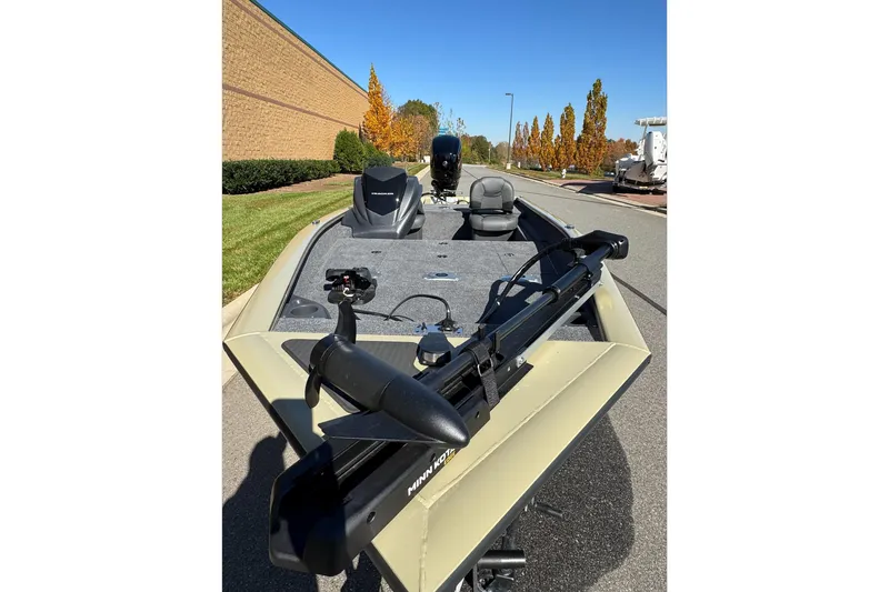 Slide: The Image of 2026 Tracker Pro Team 175 Crappie Edition boat with trolling motor on a sunny day. - 8