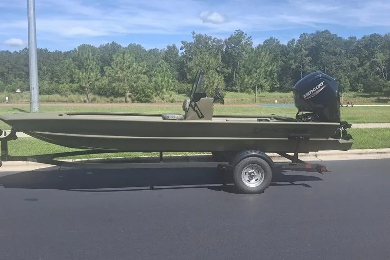The Image of 2026 Tracker Grizzly 1860 CC boat on trailer, parked on a sunny day. - 0