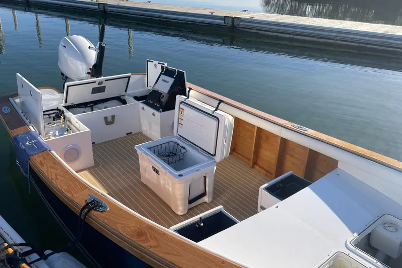 Slide: The Image of Open deck of 2025 DORRIEN YACHTS 160T 1/1 with storage and seating areas. - 18