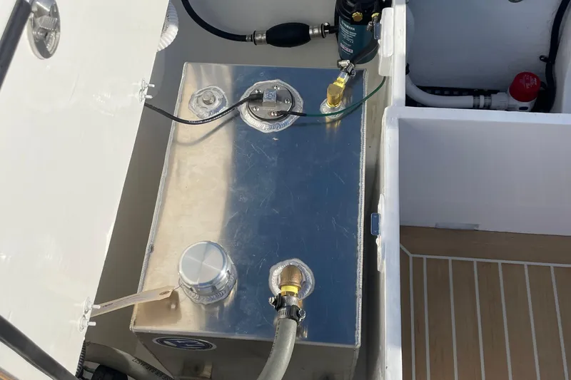 Slide: The Image of Fuel tank compartment of 2025 DORRIEN YACHTS 160T 1/1, featuring metallic components and hoses. - 23