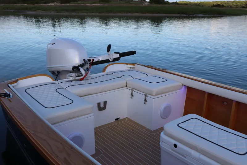 Slide: The Image of Luxurious 2025 Dorrien Yachts 160T boat interior with cushioned seating and serene water backdrop. - 5